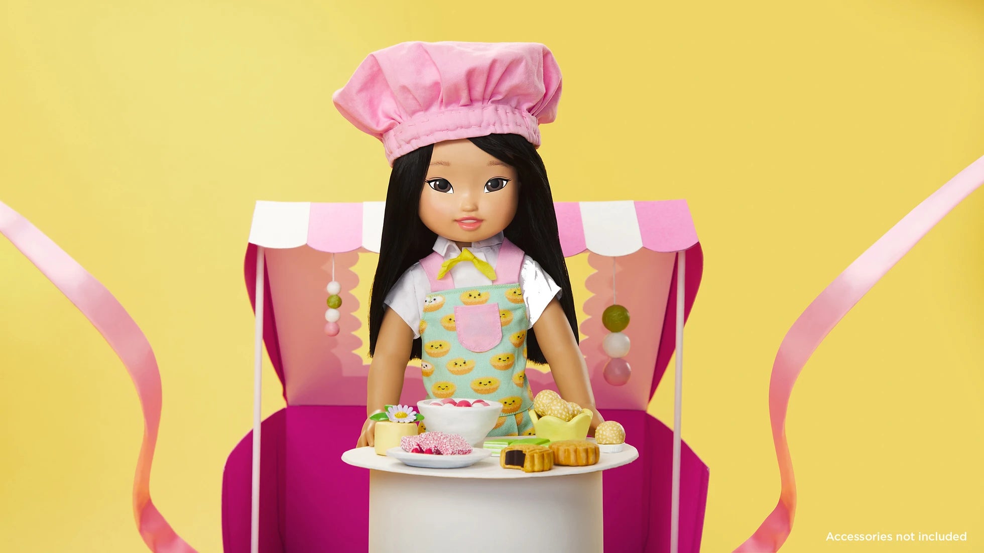 The Jilly Bing doll wearing a chef's hat with play food